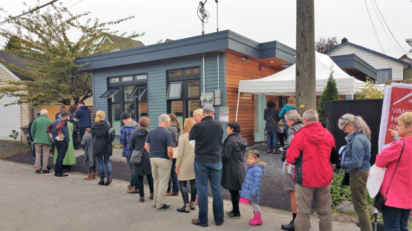 attendees-at-this-year-s-vancouver-heritage-foundation-s-laneway-house-tour-lined-up-to-view-a-small